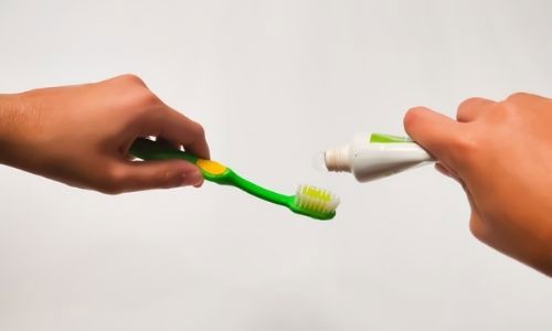 Add toothpaste onto a toothbrush